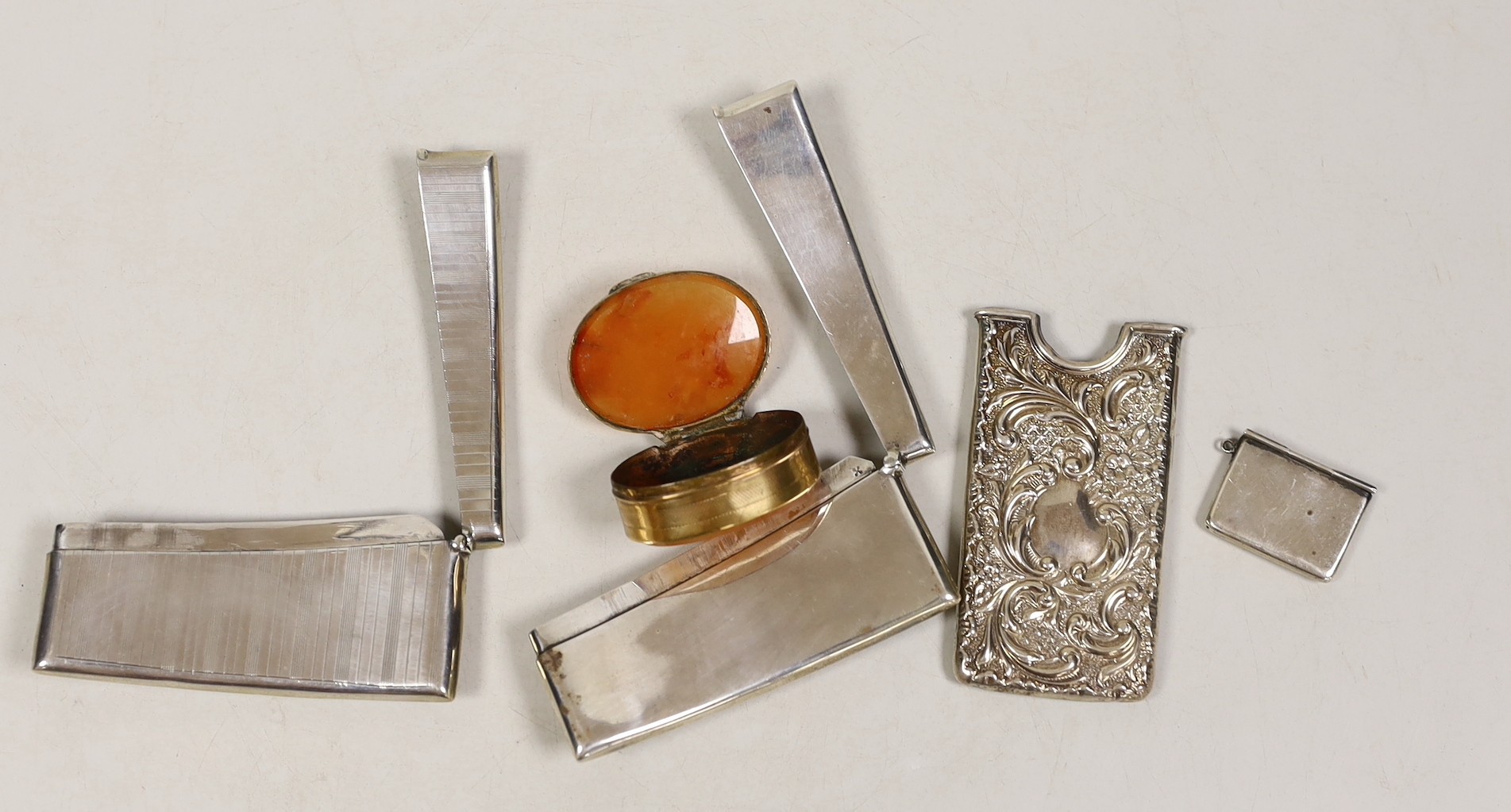 Three early 20th century card cases, including two silver and one white metal, largest 82mm an agate mounted box and a silver stamp box.